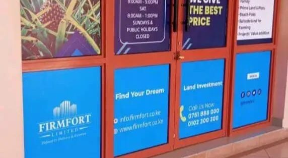Custom window branding in Kenya showing vinyl graphics and logo design on office glass